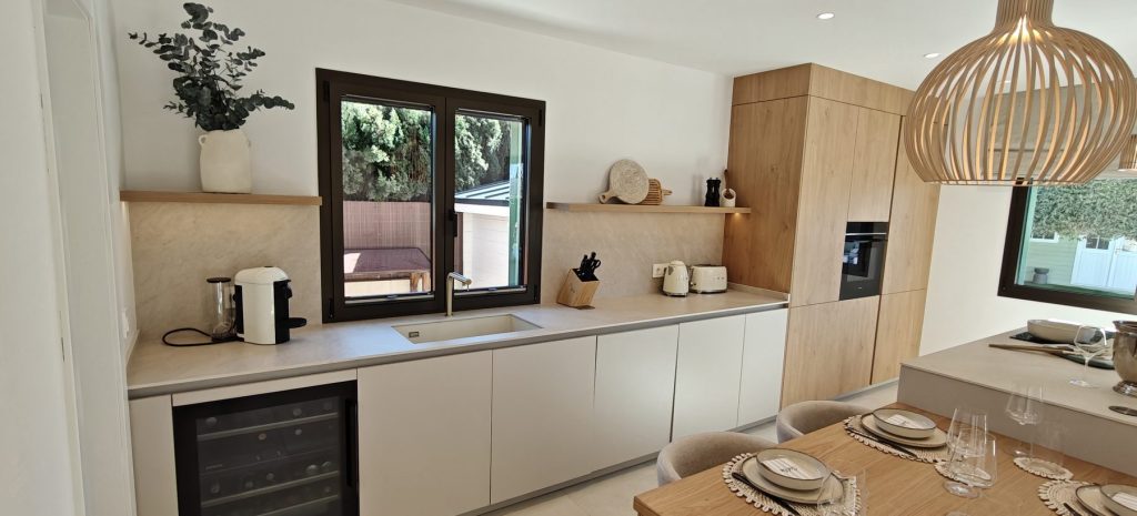Encimera de la cocina reformada con ventana al jardin en Marratxi